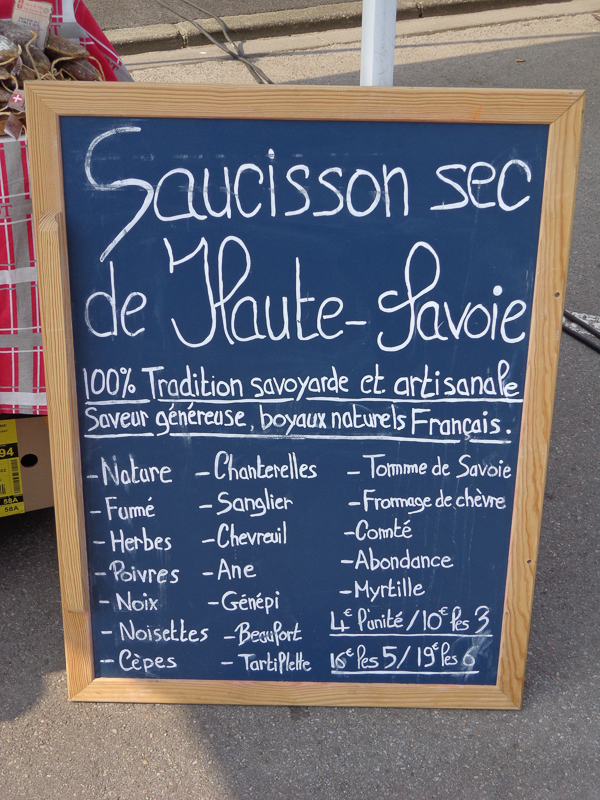 List of suasages for sale at outdoor market