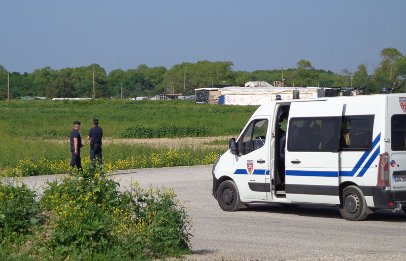 Police outside migrant camp